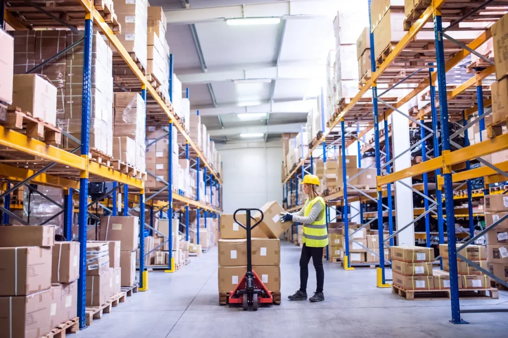 Female warehouse worker loading boxes